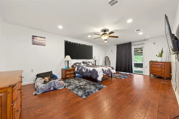 a bedroom with furniture and a flat screen tv