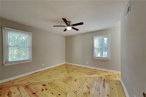 a view of a livingroom with wooden floor and a window