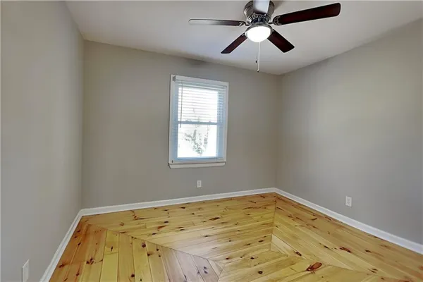a view of a room with a window and wooden floor