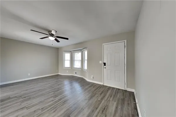 wooden floor in an empty room with a window