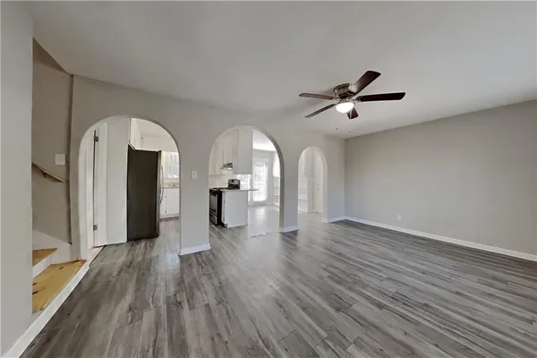 a view of empty room with wooden floor