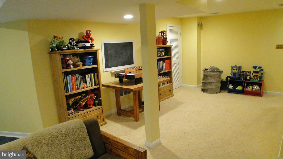 7671 Swallow Road Sykesville, MD 21784 - Photo 22 of 30 a room with furniture and a flat screen tv