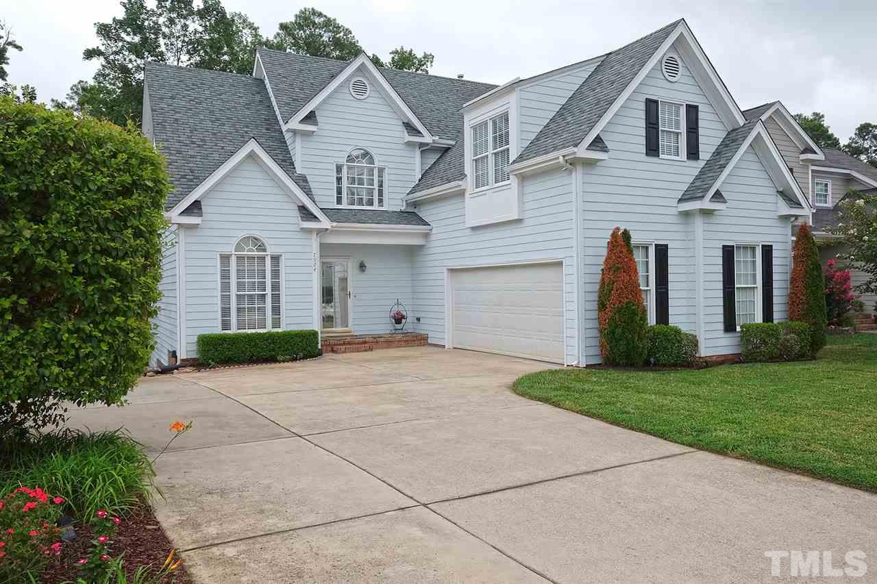 7924 Milltrace Run Raleigh, NC 27615 - Photo 1 of 25 a front view of a house with a yard and garage