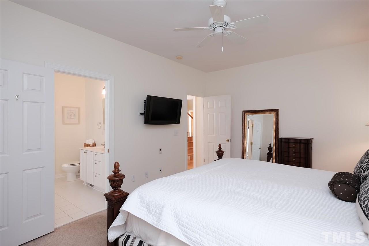 7924 Milltrace Run Raleigh, NC 27615 - Photo 11 of 25 a bedroom with a bed and a flat screen tv
