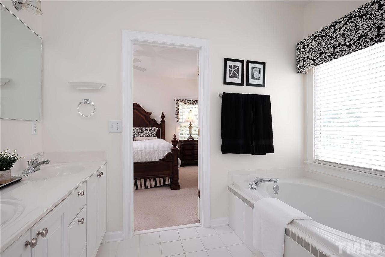 7924 Milltrace Run Raleigh, NC 27615 - Photo 13 of 25 a en suite bathroom with a toilet sink and mirror