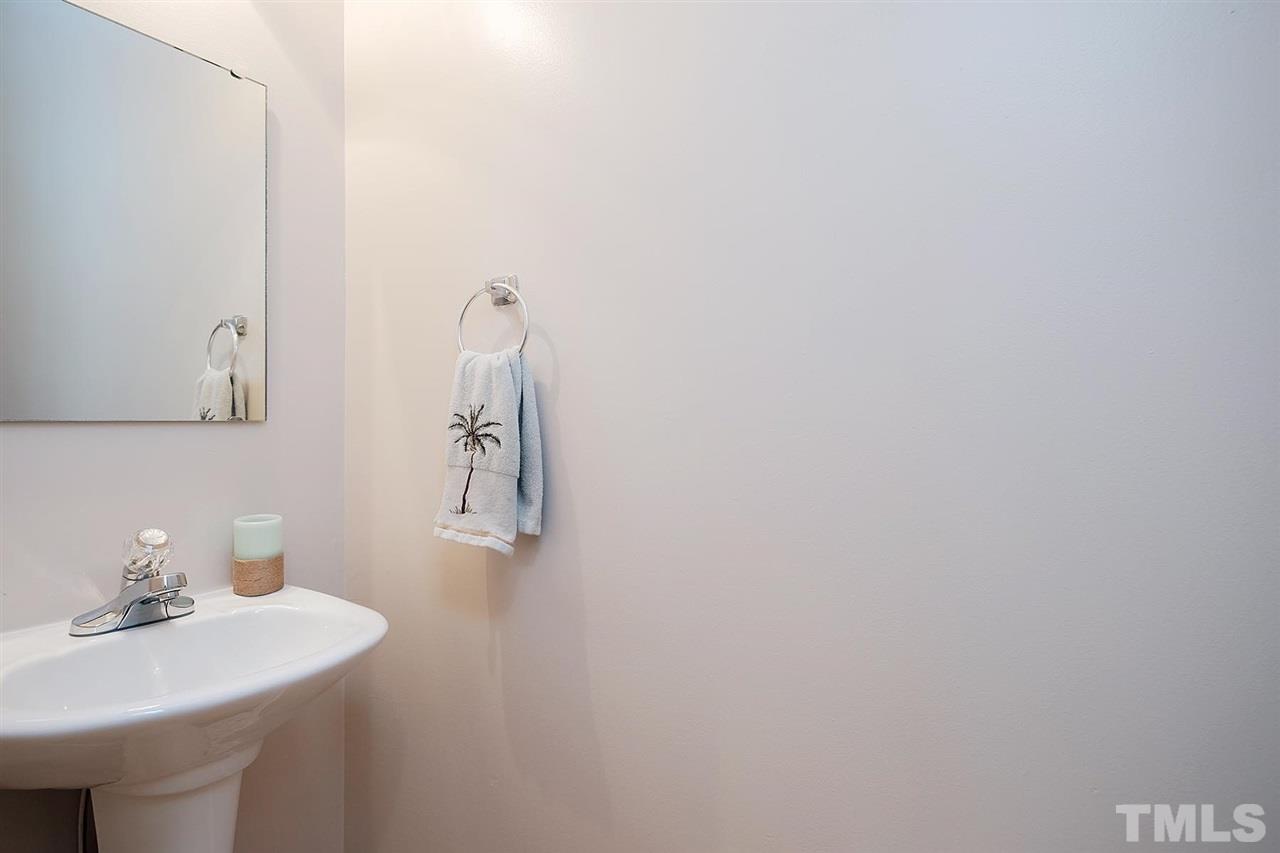 7924 Milltrace Run Raleigh, NC 27615 - Photo 14 of 25 a bathroom with a sink a mirror and vanity