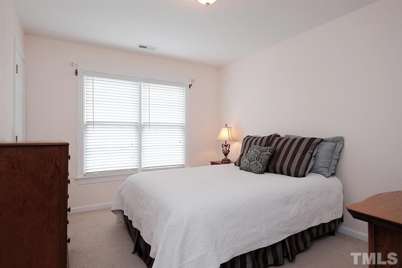 7924 Milltrace Run Raleigh, NC 27615 - Photo 15 of 25 a large bed sitting in a bedroom next to a window