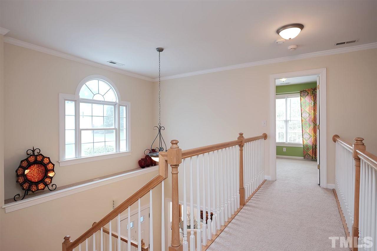 7924 Milltrace Run Raleigh, NC 27615 - Photo 18 of 25 a view of hallway with stairs and a window
