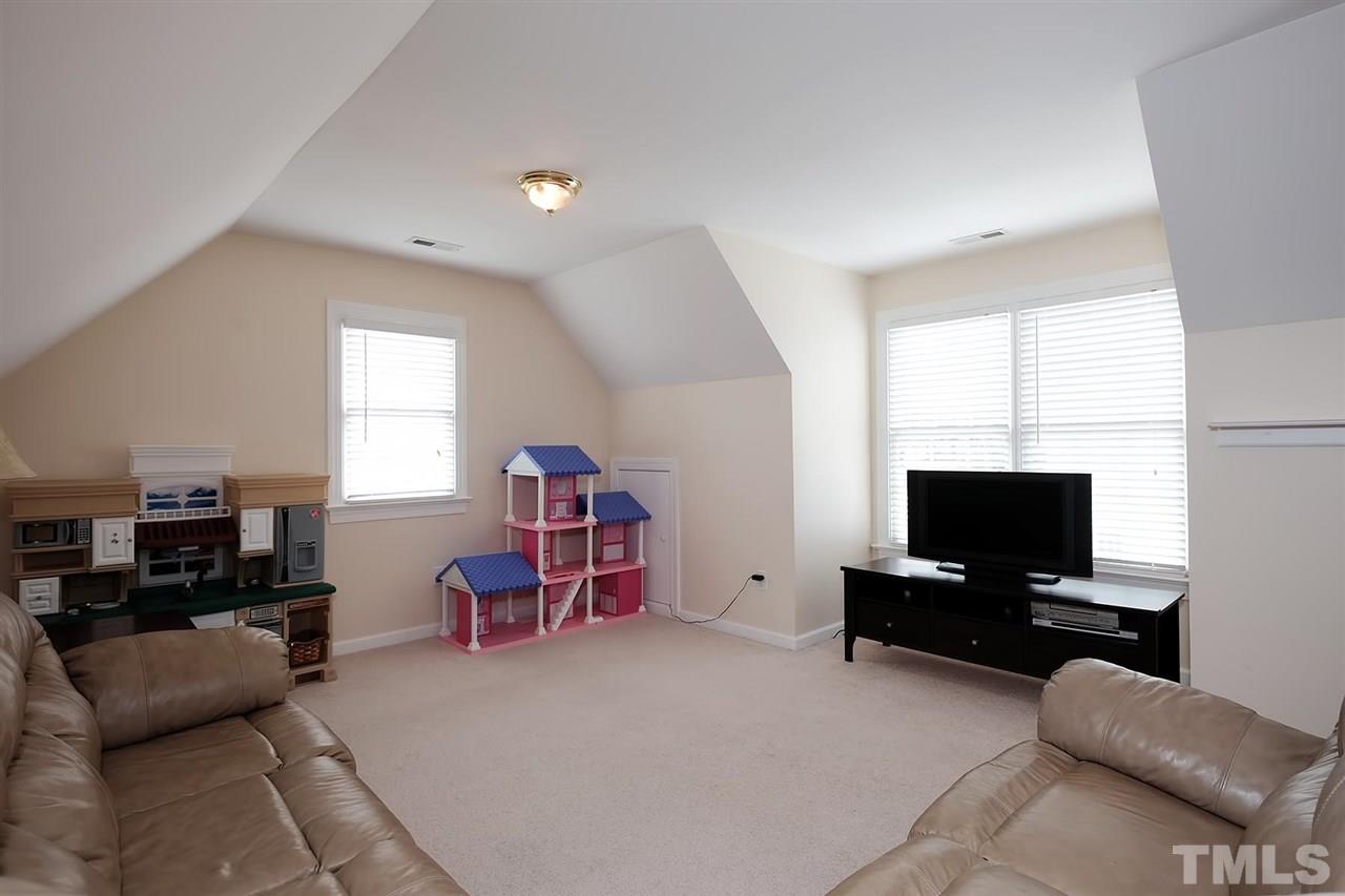 7924 Milltrace Run Raleigh, NC 27615 - Photo 19 of 25 a living room with furniture and a flat screen tv