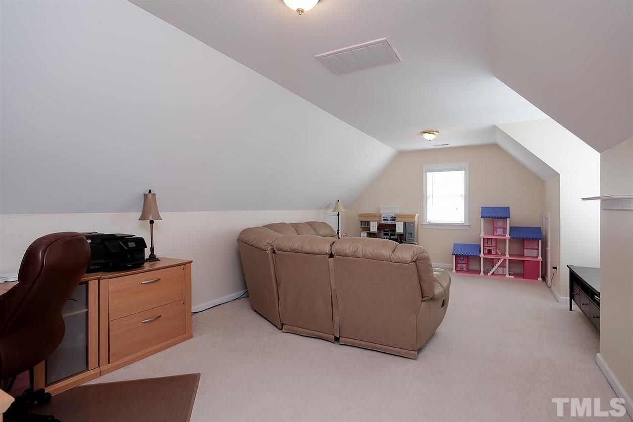 7924 Milltrace Run Raleigh, NC 27615 - Photo 20 of 25 a living room with furniture and a window