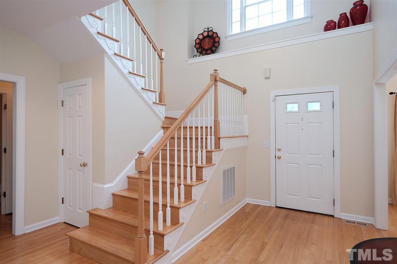 7924 Milltrace Run Raleigh, NC 27615 - Photo 2 of 25 a view of staircase with wooden floor and white walls