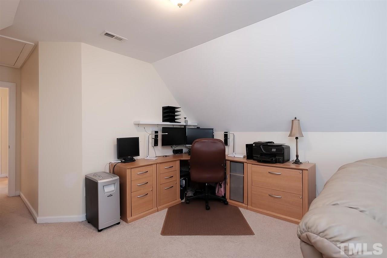 7924 Milltrace Run Raleigh, NC 27615 - Photo 21 of 25 a view of a workspace with furniture and a window