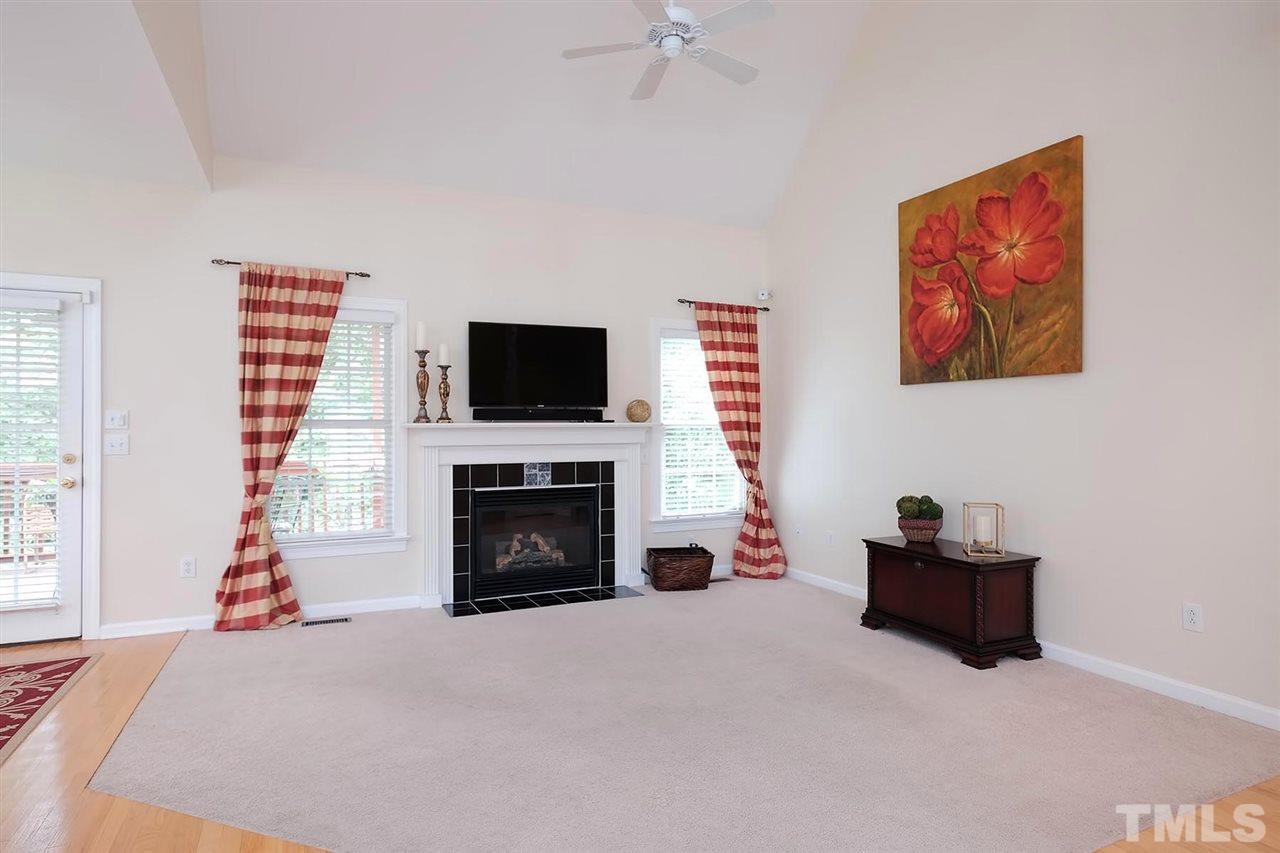 7924 Milltrace Run Raleigh, NC 27615 - Photo 5 of 25 a living room with furniture and a fireplace