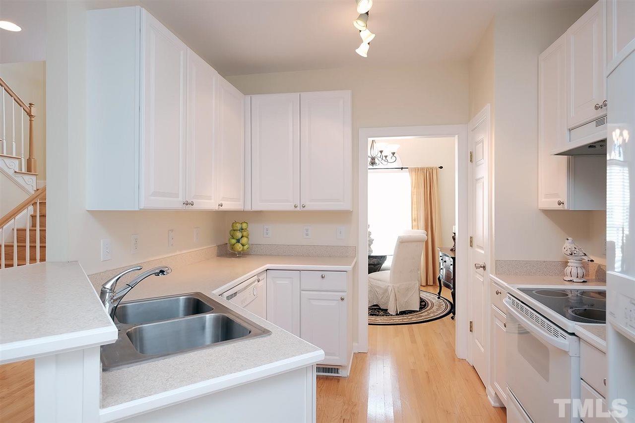 7924 Milltrace Run Raleigh, NC 27615 - Photo 7 of 25 a kitchen with a sink a stove and cabinets