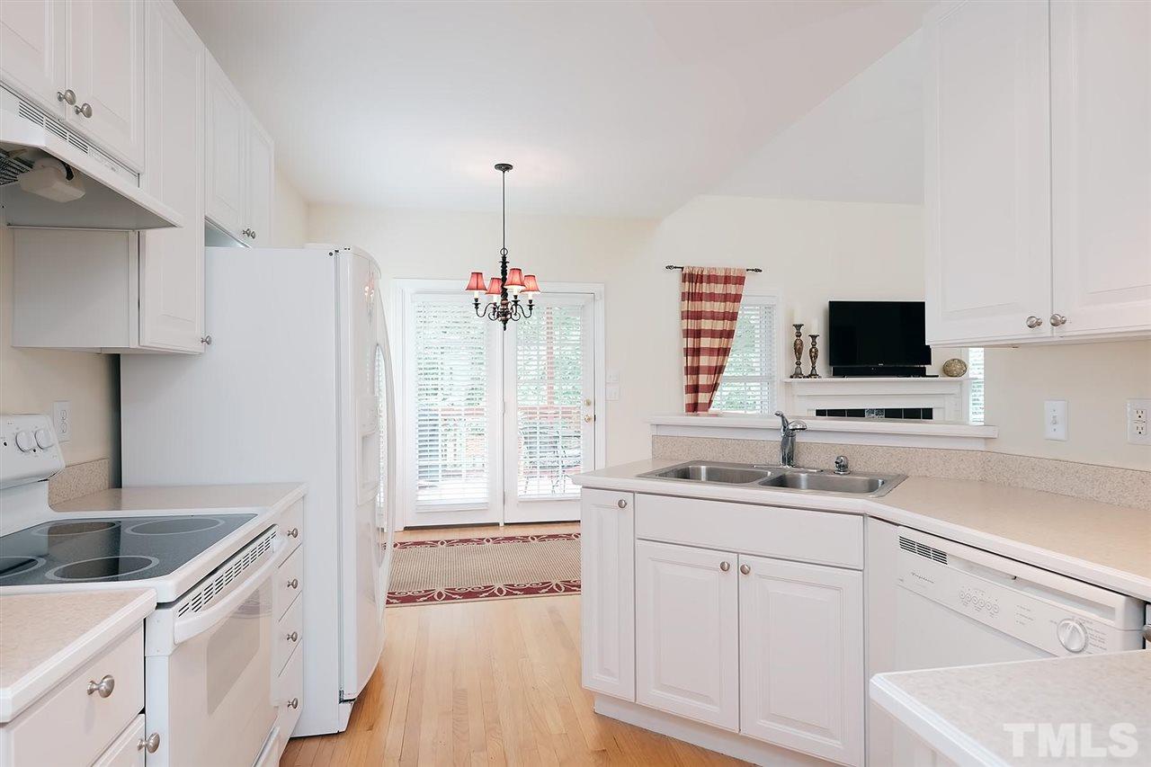 7924 Milltrace Run Raleigh, NC 27615 - Photo 8 of 25 a kitchen with a sink stove and cabinets
