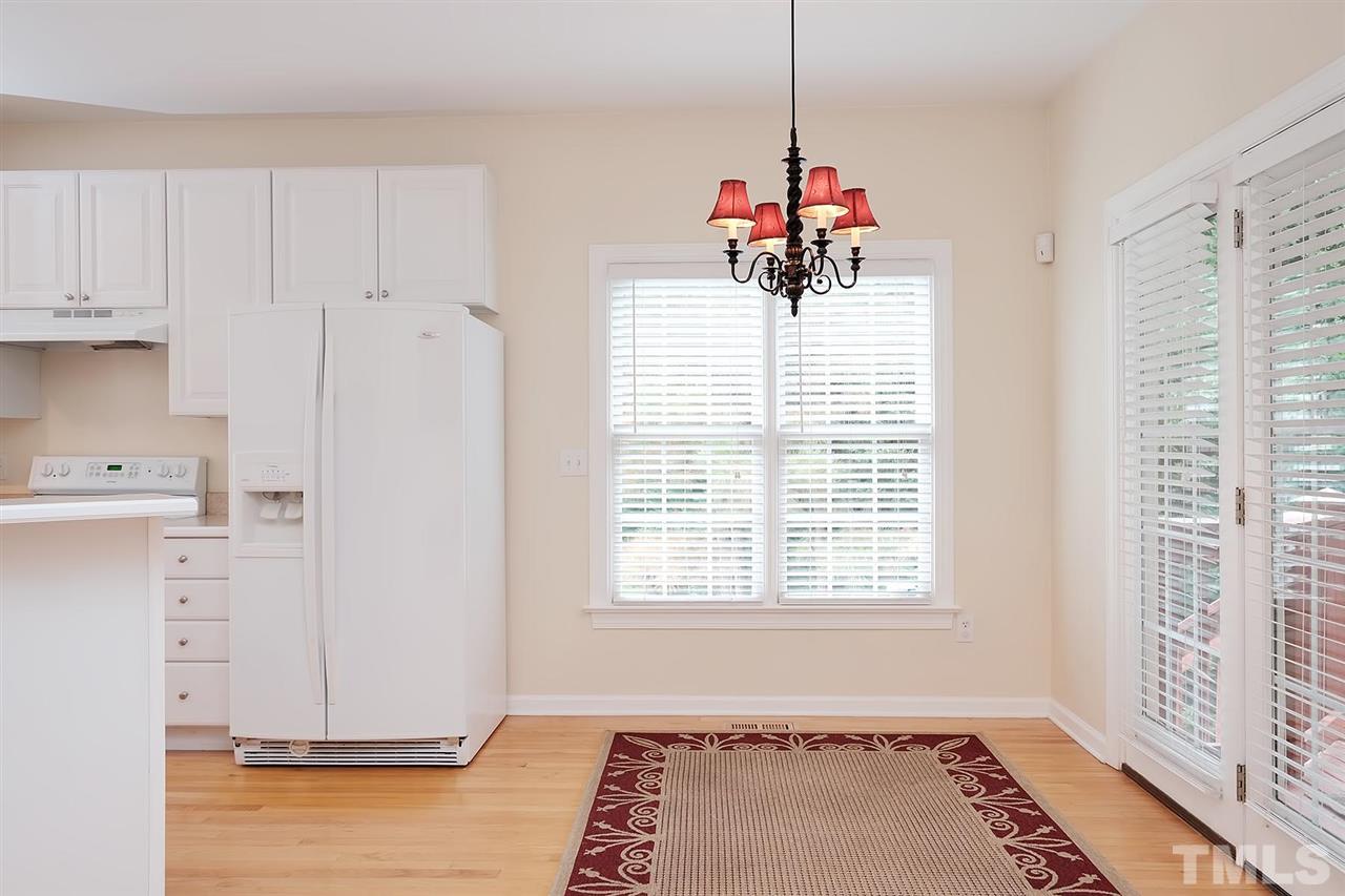 7924 Milltrace Run Raleigh, NC 27615 - Photo 9 of 25 a view of a kitchen with a window and a chandelier