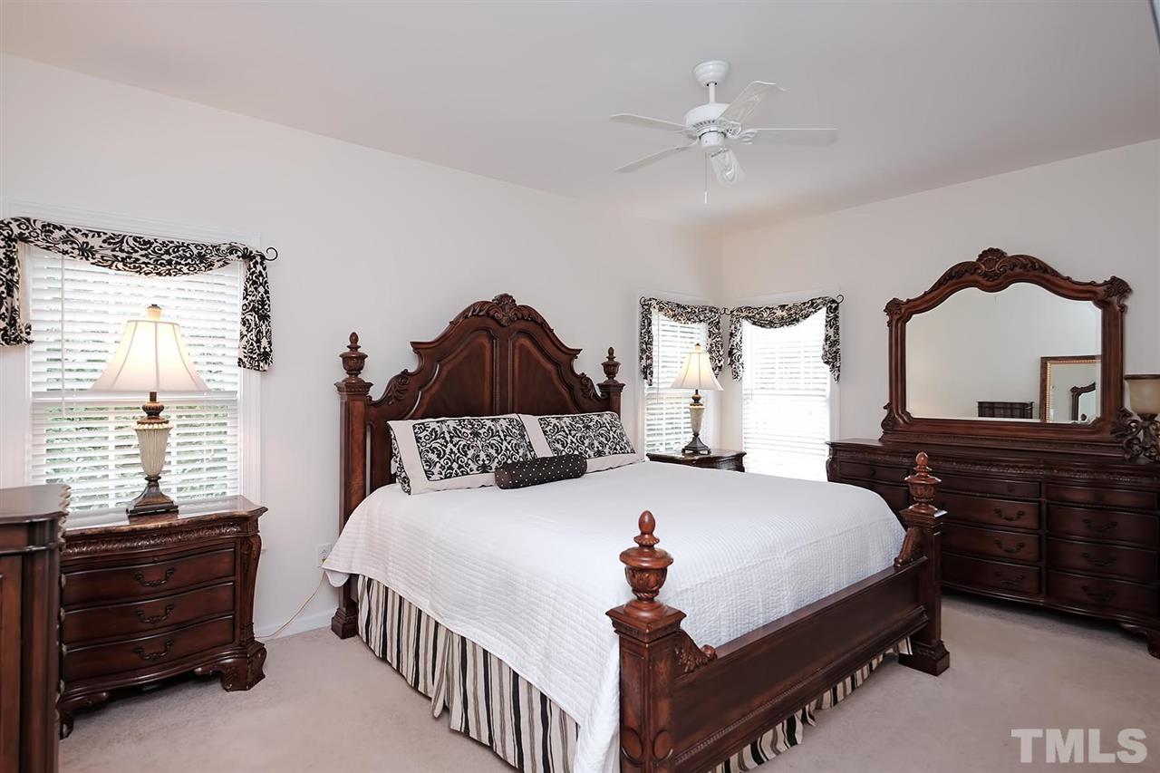 7924 Milltrace Run Raleigh, NC 27615 - Photo 10 of 25 a bedroom with a bed and a dresser