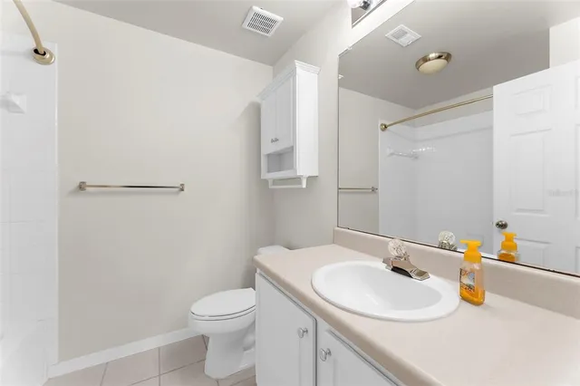 a view of an empty room with a ceiling fan
