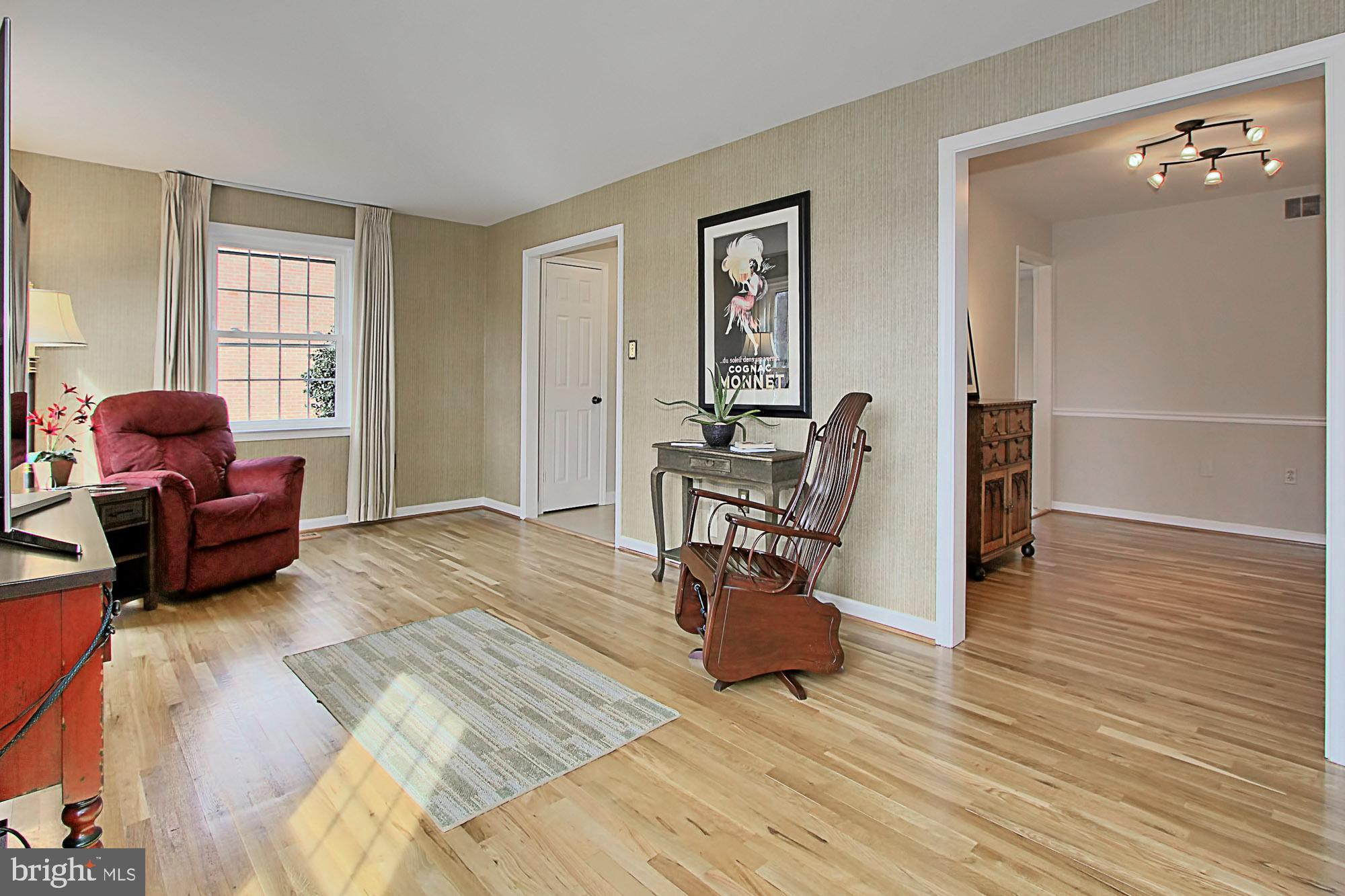 7013 Leestone Street Springfield, VA 22151 - Photo 13 of 36 a living room with furniture and a wooden floor