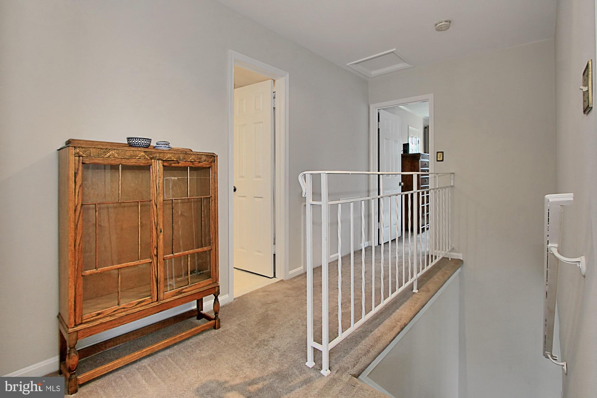 7013 Leestone Street Springfield, VA 22151 - Photo 18 of 36 a view of a livingroom with wooden floor and white walls
