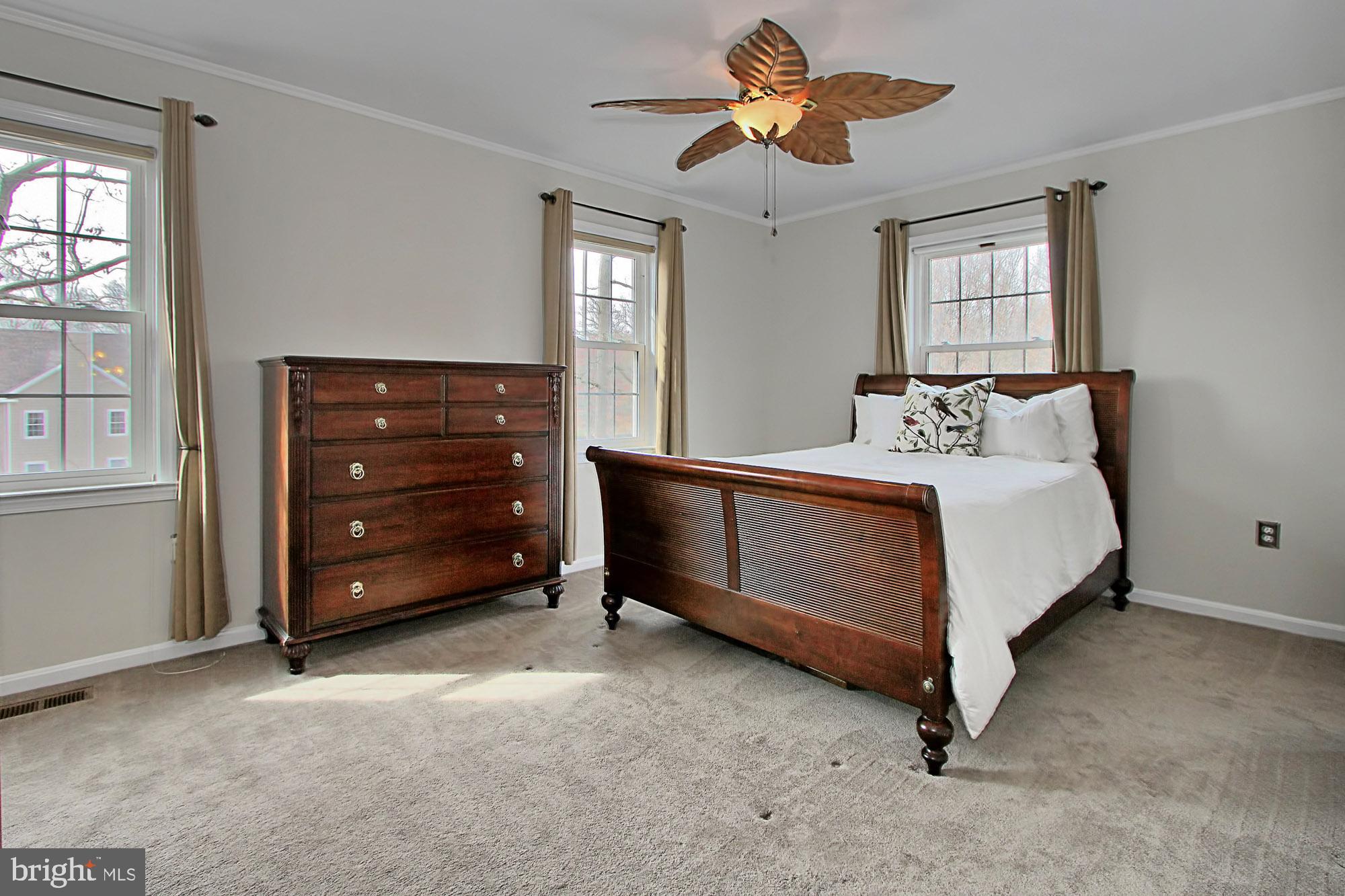 7013 Leestone Street Springfield, VA 22151 - Photo 19 of 36 a bedroom with a bed and a chandelier