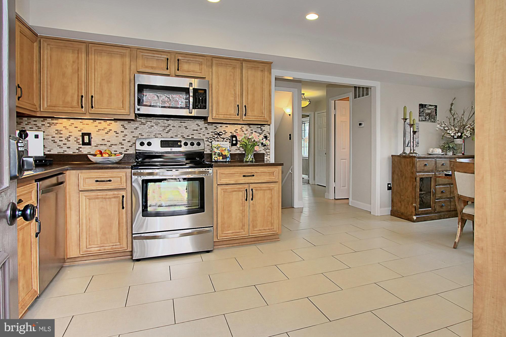 7013 Leestone Street Springfield, VA 22151 - Photo 3 of 36 a kitchen with white cabinets and appliances