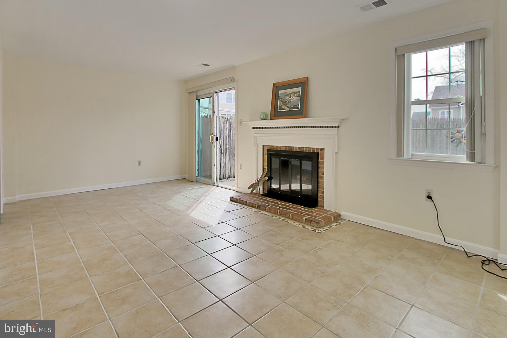 7013 Leestone Street Springfield, VA 22151 - Photo 28 of 36 a view of an empty room with a fireplace and a window