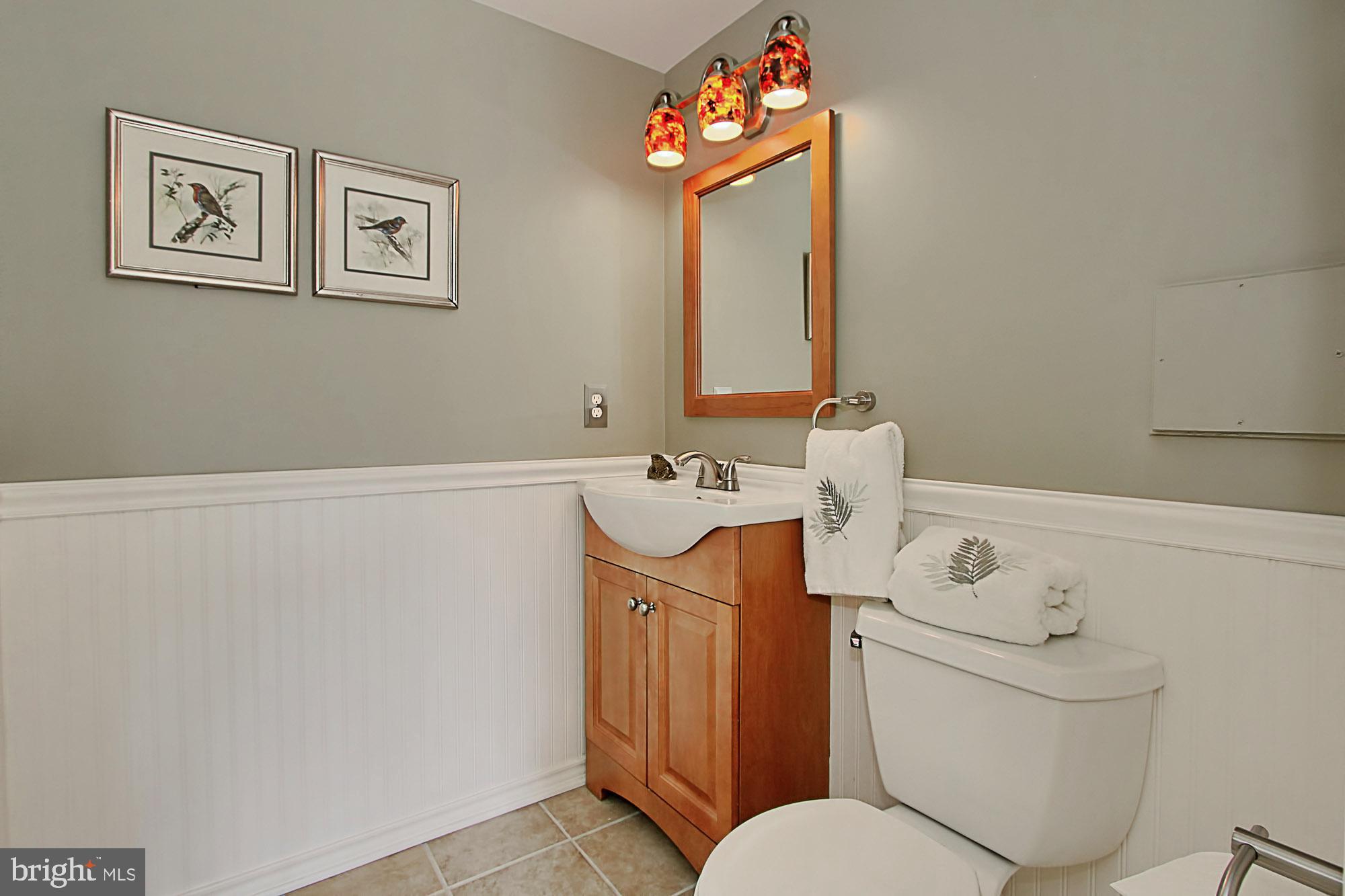 7013 Leestone Street Springfield, VA 22151 - Photo 29 of 36 a bathroom with a sink mirror vanity and toilet