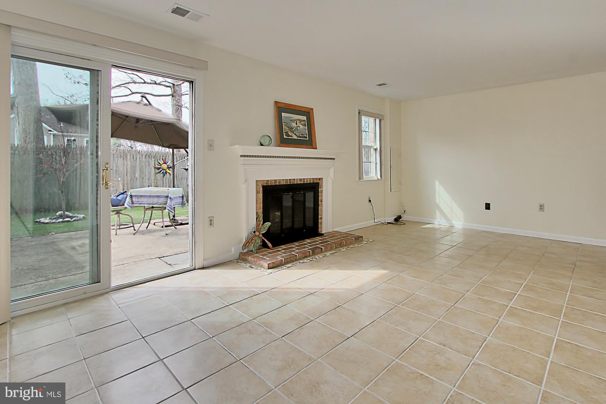 7013 Leestone Street Springfield, VA 22151 - Photo 30 of 36 a view of an empty room with window and a fireplace