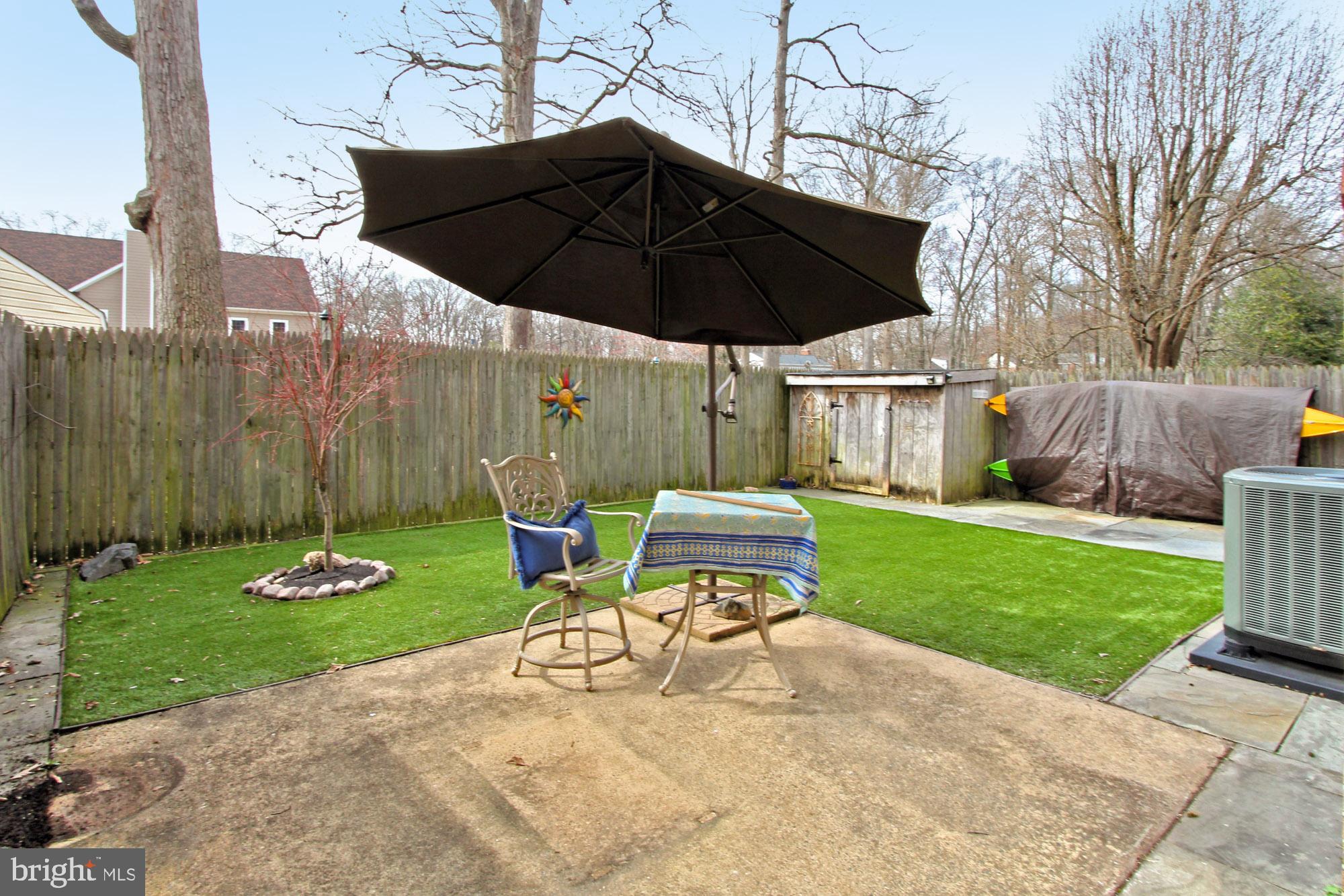 7013 Leestone Street Springfield, VA 22151 - Photo 31 of 36 a view of a chair and table under an umbrella in backyard