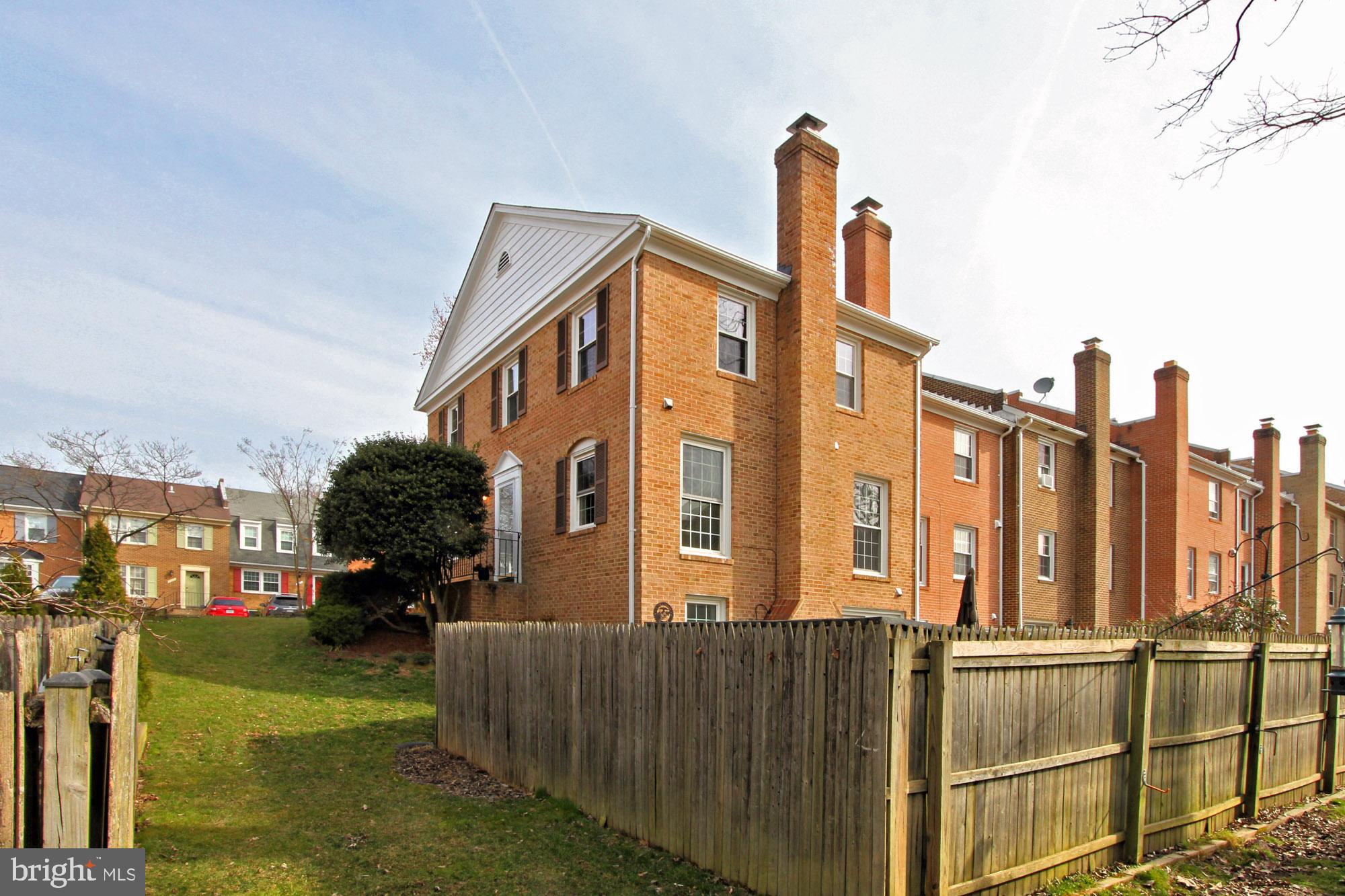 7013 Leestone Street Springfield, VA 22151 - Photo 33 of 36 a front view of a residential apartment building with a yard