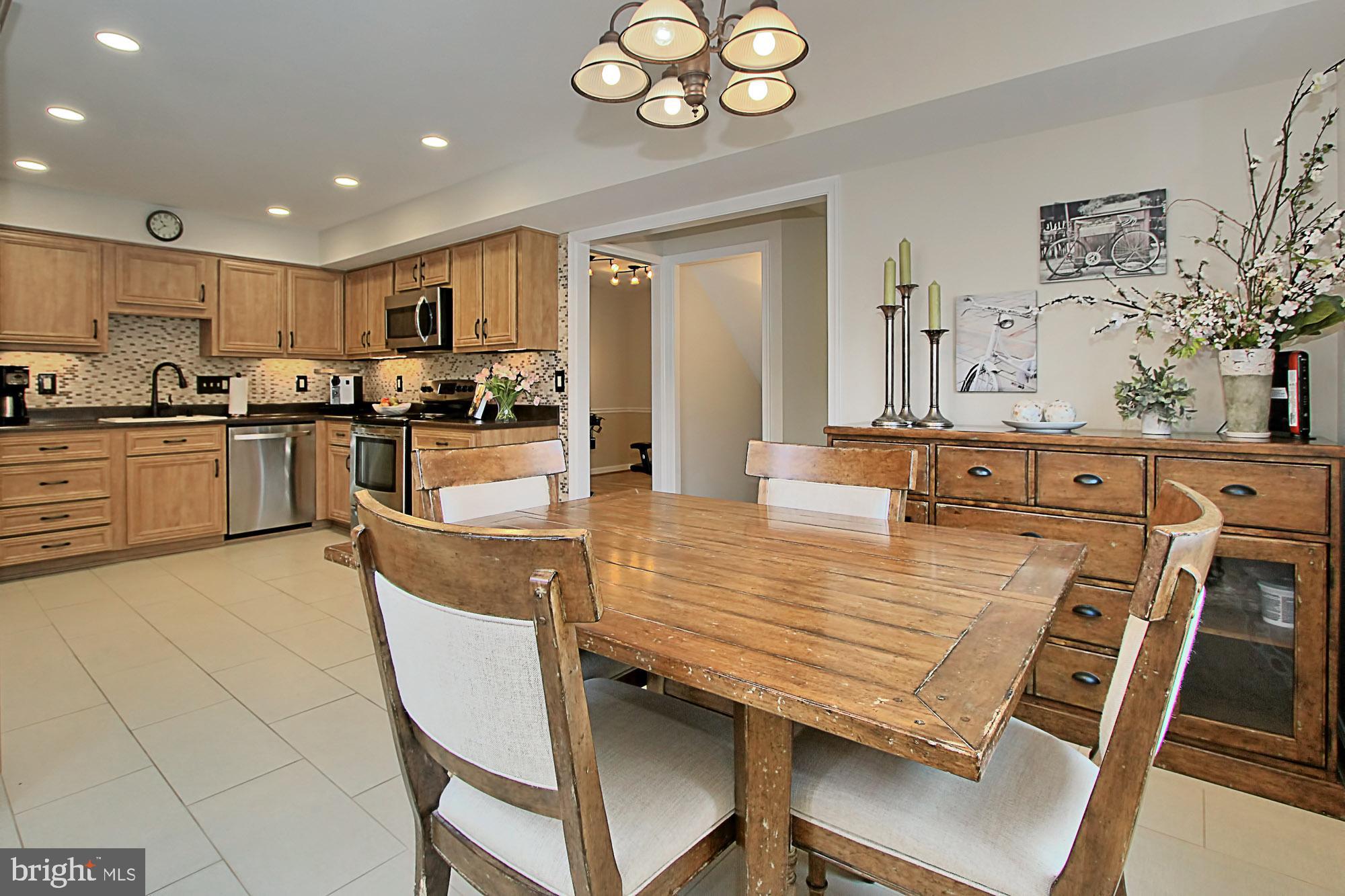 7013 Leestone Street Springfield, VA 22151 - Photo 10 of 36 a large kitchen with a table and chairs in it