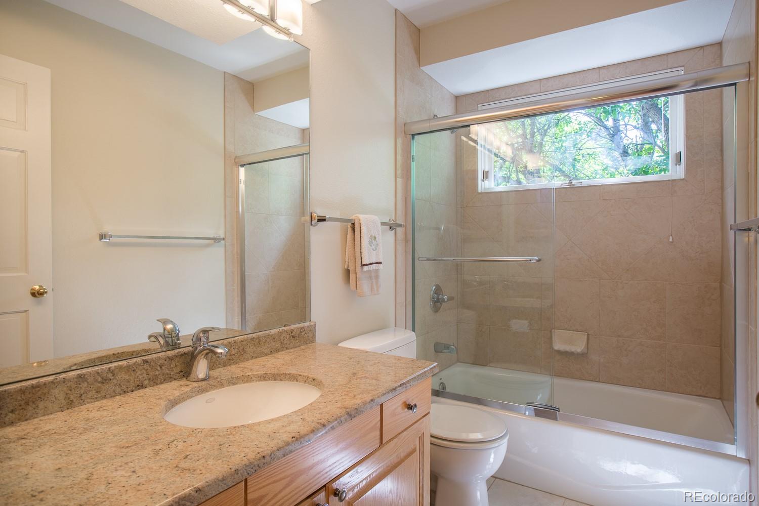 1151 Juniper Avenue Boulder, CO 80304 - Photo 19 of 37 a bathroom with a granite countertop sink toilet and shower