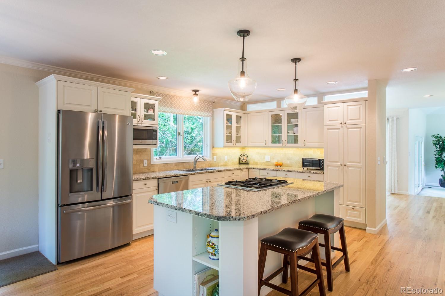 1151 Juniper Avenue Boulder, CO 80304 - Photo 7 of 37 a kitchen with stainless steel appliances granite countertop a stove refrigerator and wooden floor