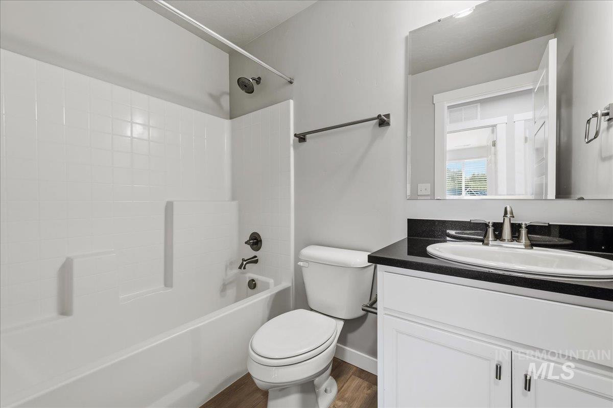 12509 West Victory Road Boise, ID 83709 - Photo 18 of 23 White vanity with a dark countertop and undermount sink