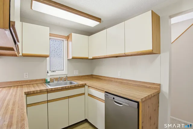 a kitchen with a sink cabinets and a window