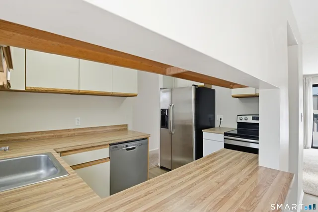 a kitchen with a sink cabinets and stainless steel appliances