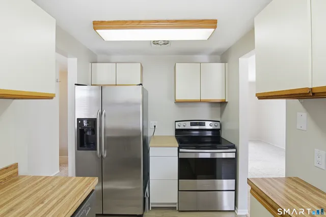 a kitchen with a refrigerator and a stove
