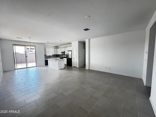 a view of a livingroom with furniture and an empty room