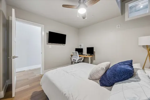 a bedroom with a bed and a flat screen tv