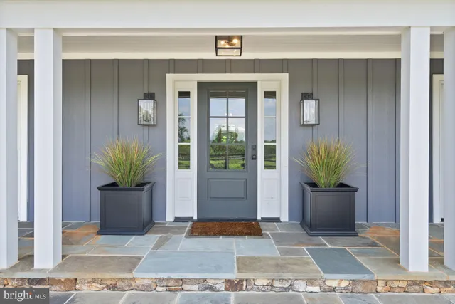 a bed sitting in a spacious bedroom next to a window