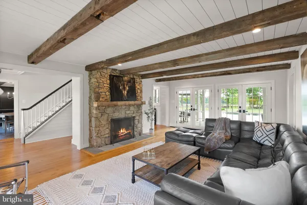 a bathroom with a granite countertop sink a mirror and a shower