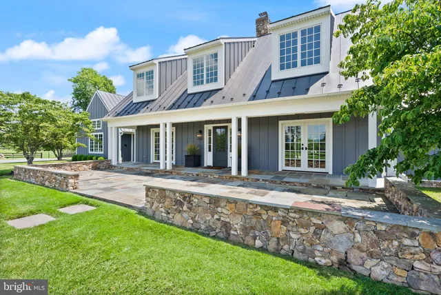 a view of a house with pool fire pit and chairs in a yard