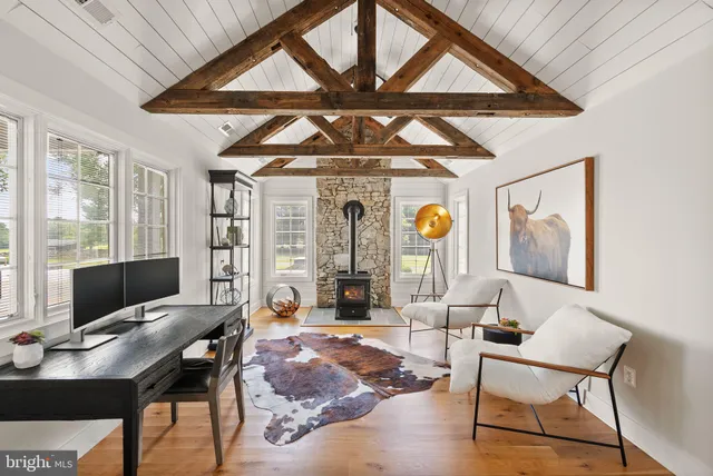 a view of a livingroom with furniture wooden floor and windows