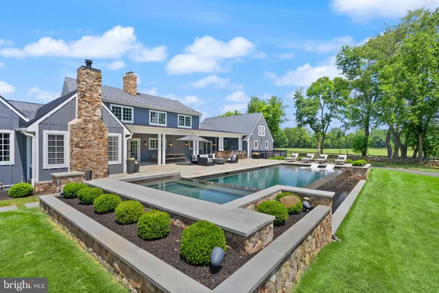 a view of park with bench in front of house