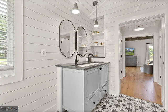 a view of a hallway view with wooden floor and staircase