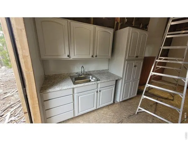 a kitchen with a white cabinets and white appliances