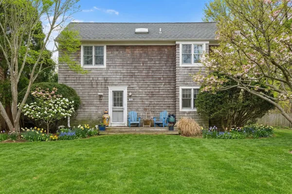 a front view of house with yard and outdoor seating