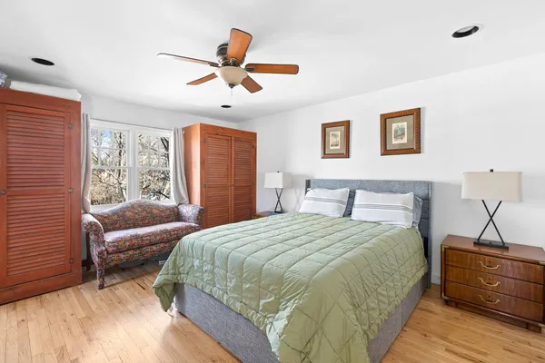 a spacious bedroom with a bed and a couch