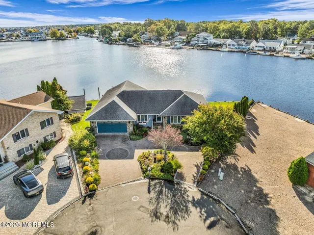 an aerial view of a house with a lake view